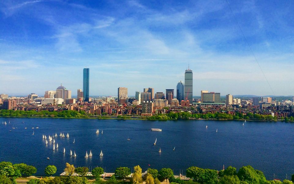 Boston skyline across the Charles River with sailboats on the water