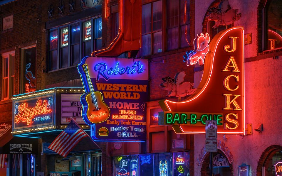 Neon honky-tonk signs on Broadway in Nashville at night