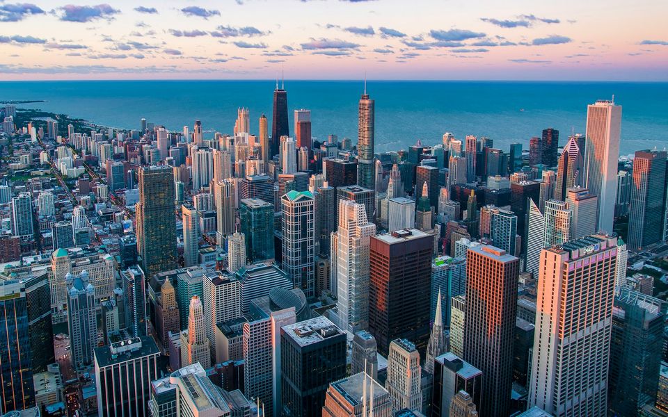 Aerial view of the Chicago skyline beside Lake Michigan at sunset