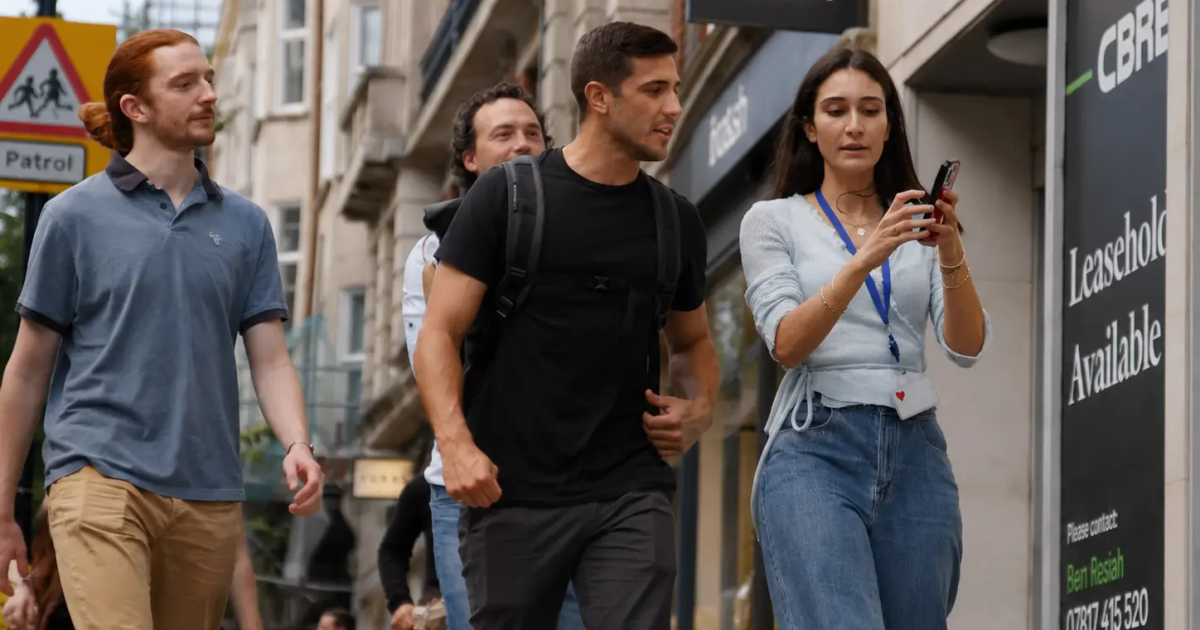A group of colleagues exploring a city together on a GPS treasure hunt team building activity