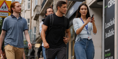 A group of colleagues exploring a city together on a GPS treasure hunt team building activity