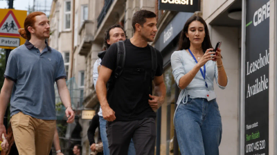 A group of colleagues exploring a city together on a GPS treasure hunt team building activity