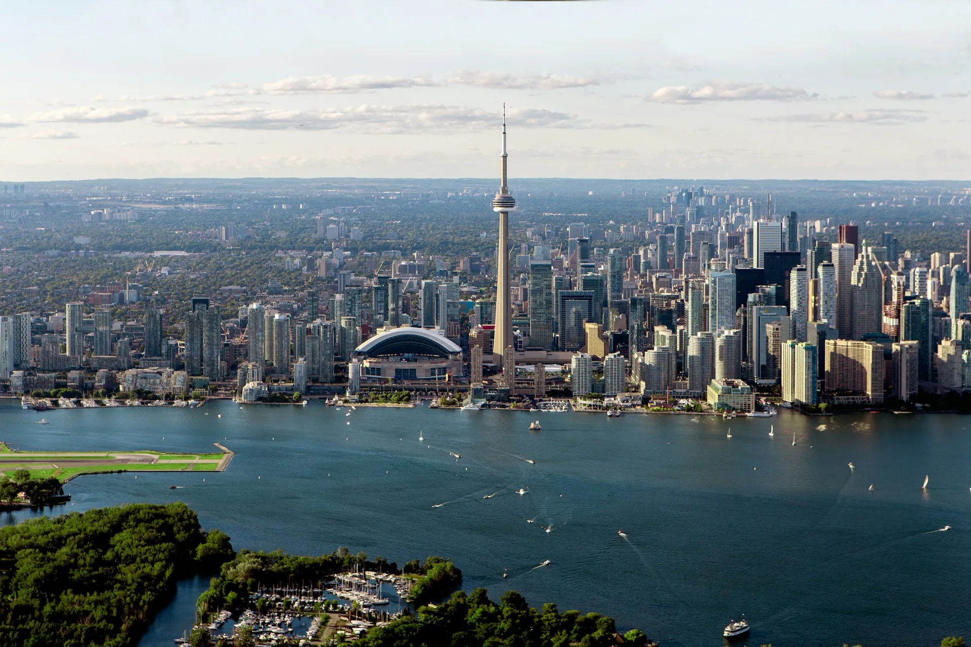 Toronto skyline across Lake Ontario with the CN Tower and Rogers Centre, boats on the water