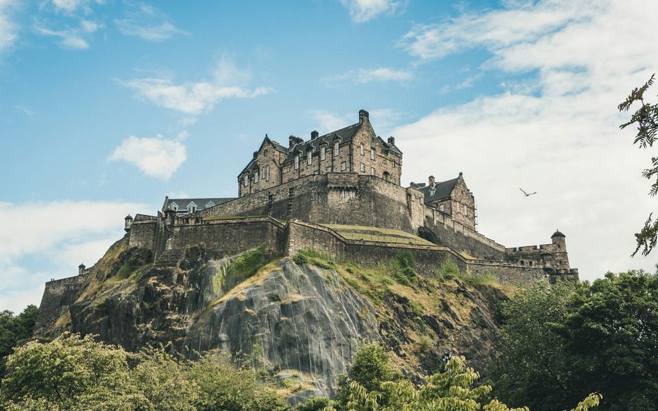 Edinburgh Castle on Castle Rock against a blue sky