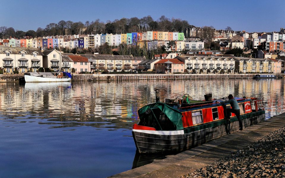 Colourful Bristol harbourside houses reflected in the water