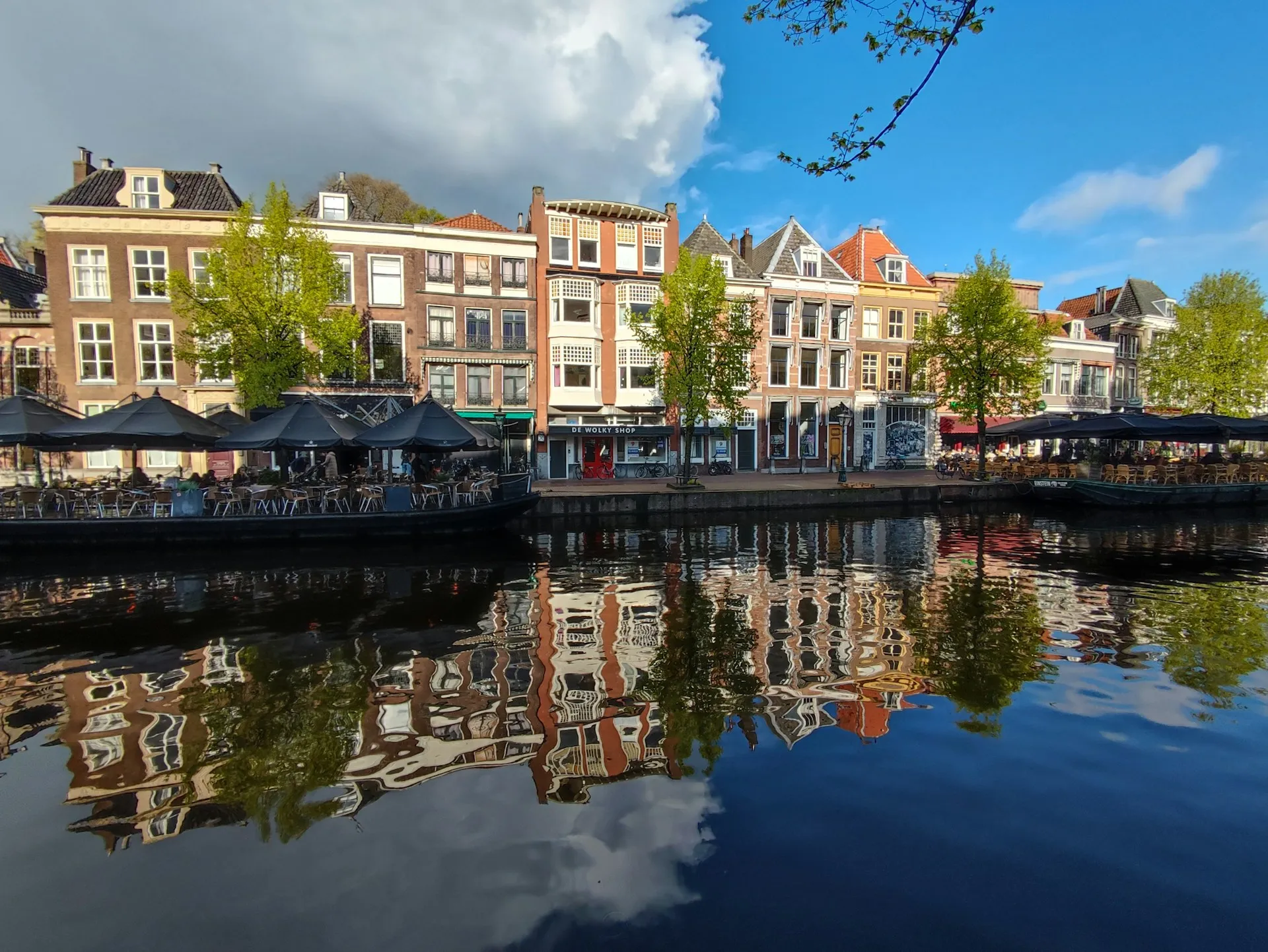 Historische grachtenpanden weerspiegeld in het water in Leiden
