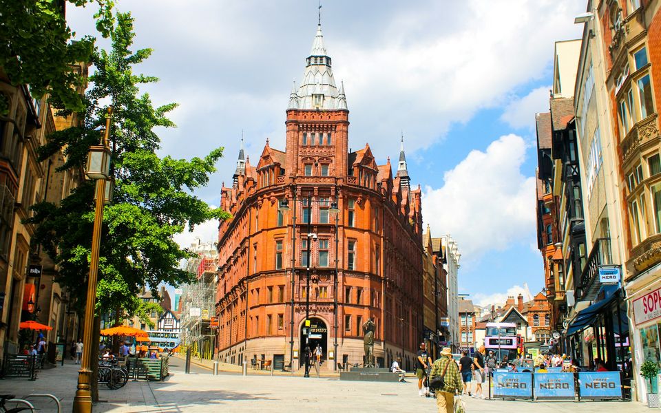Nottingham city street with ornate red brick building