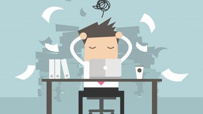 A flat vector illustration of an overwhelmed office worker holding his head in stress at his desk, surrounded by flying sheets of paper and massive piles of paperwork.