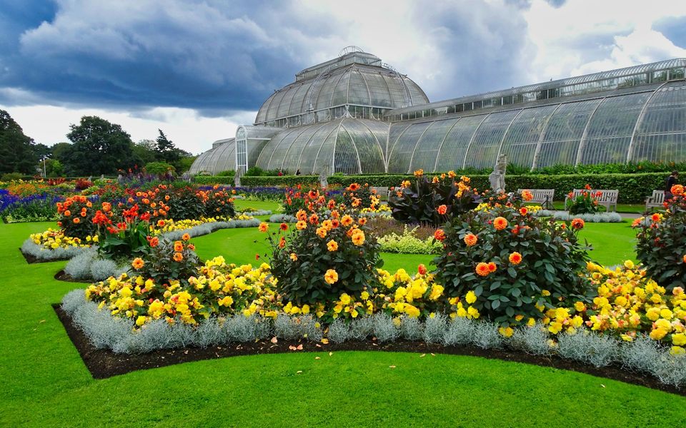 Kew Gardens glasshouse with colourful flower beds