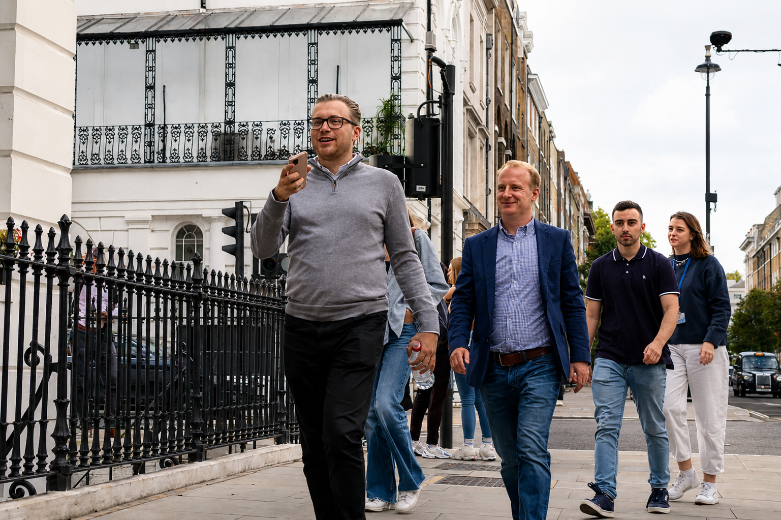 Team of employees exploring an urban area together as part of a treasure hunt theme team building event.